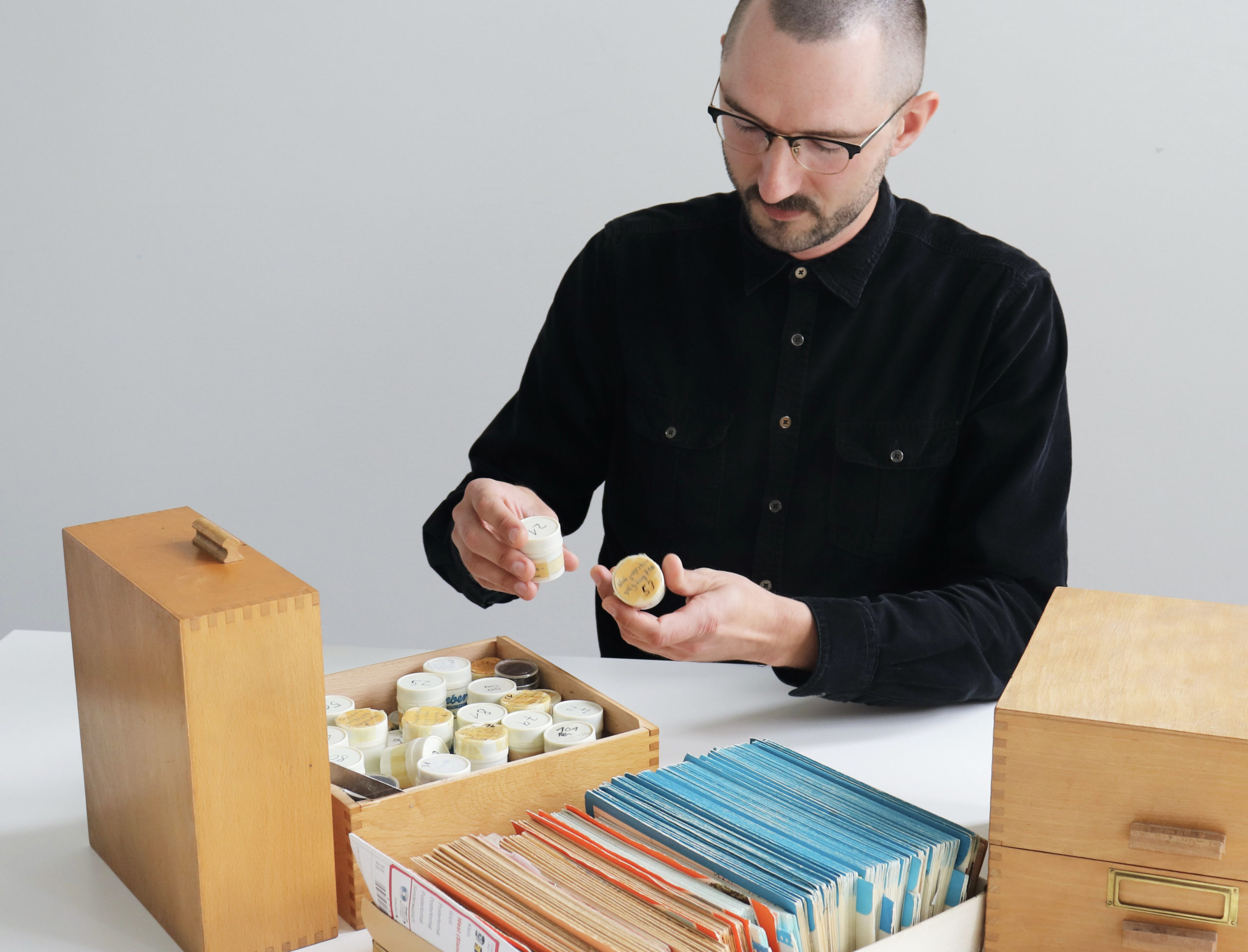 Johannes Christof betrachtet den Fotobestand vom Dachboden des Ständehaus